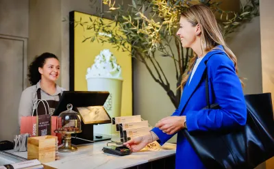 woman paying at Madaq point of sale